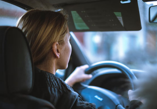 Inside view of woman driving car